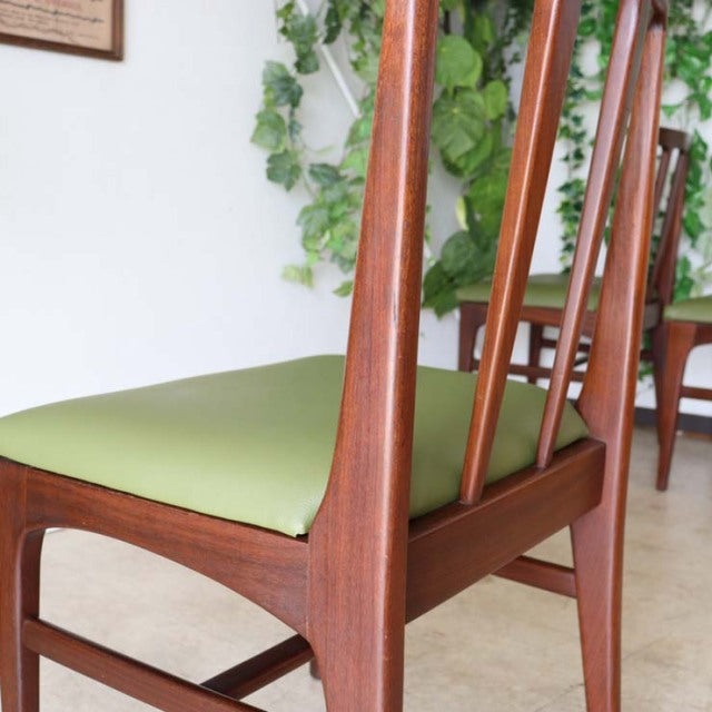 Vintage British mid-century teak dining chair by A.Younger Ltd. with green upholstered seat and sleek tapered back legs.