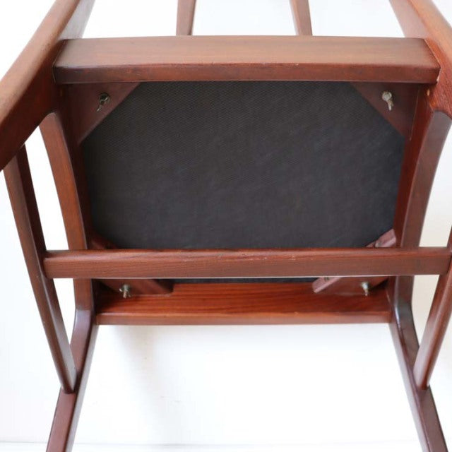 Underside view of mid-century vintage teak dining chair by A.Younger Ltd., sturdy angled legs and visible wood grain.