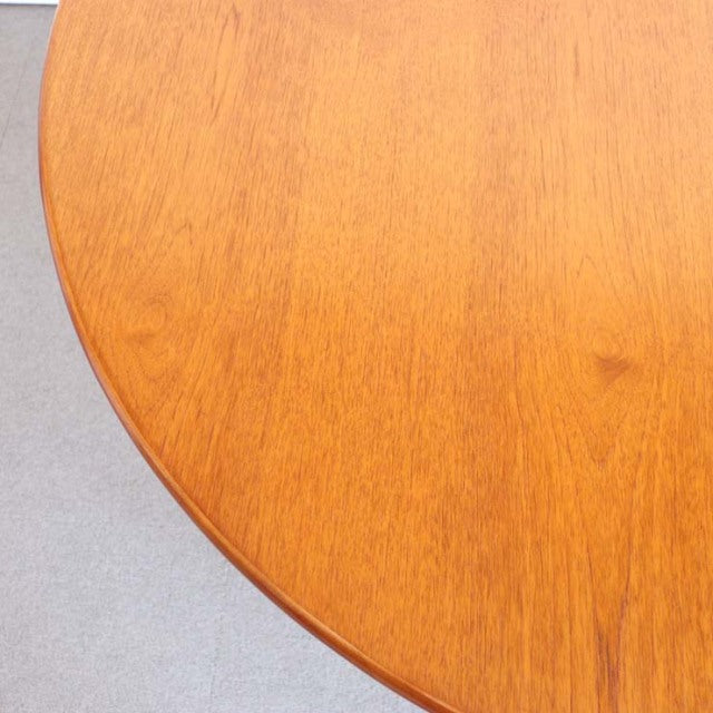 Round mid-century vintage teak dining table top showing warm wood grain and smooth finish from British vintage collection.