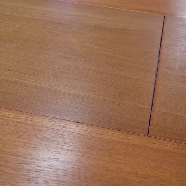 Vintage British mid-century teak dining table top with smooth wood grain and subtle panel detailing.