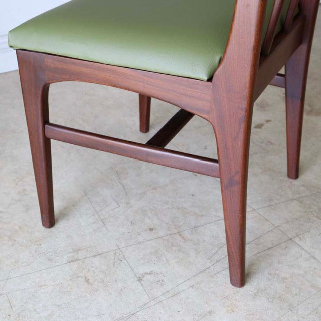 Mid-century British teak dining chair by A.Younger Ltd., green leather seat, tapered legs with visible teak grain and smooth .