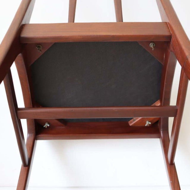Mid-century British vintage teak dining chair underside showing solid wood frame and craftsmanship details.