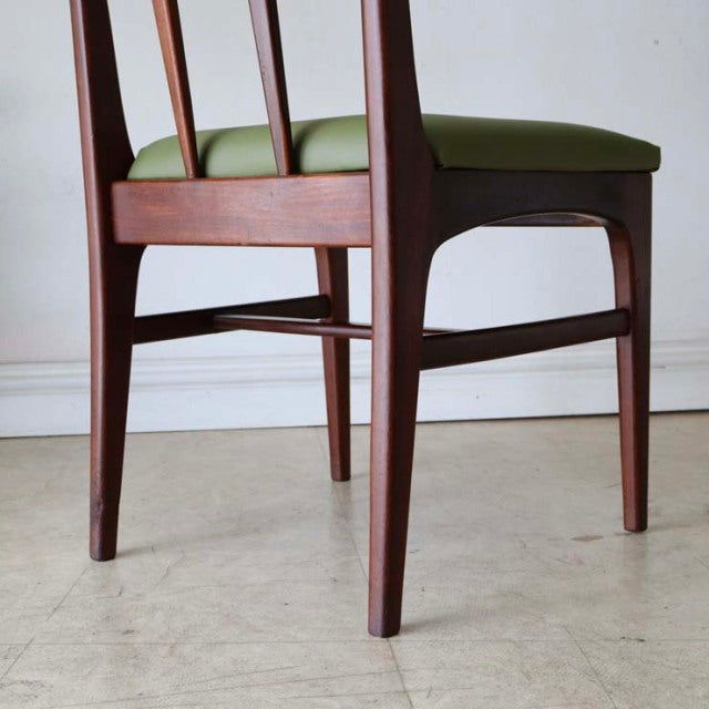 Mid-century British vintage teak dining chair with green upholstered seat and slender tapered legs, designed by John Herbert .