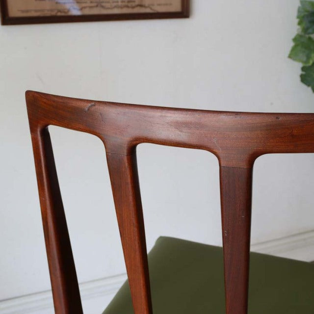 Vintage mid-century teak dining chair backrest designed by John Herbert Fonseca with smooth wood grain, elegant.