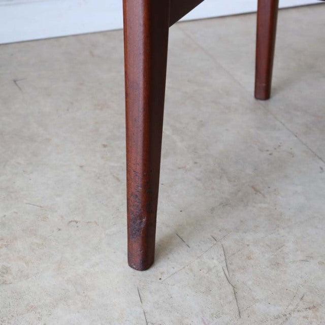 Mid-century teak dining chair leg by A.Younger Ltd., showcasing warm wood grain and slender British design from Denmark style.