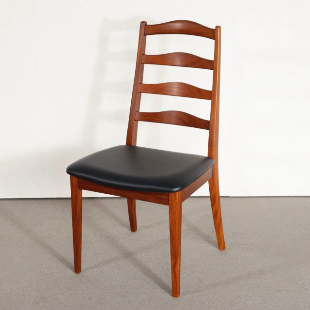 Mid-century British G-PLAN teak dining chair with ladder back and black leather seat, sleek wood grain visible.