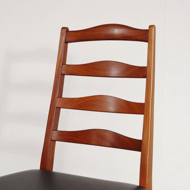 Vintage mid-century British G-Plan teak dining chair with curved slatted back and dark cushioned seat.