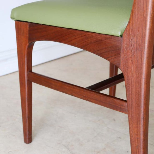 Mid-century British vintage teak dining chair leg and frame with rich wood grain and olive green upholstered seat.