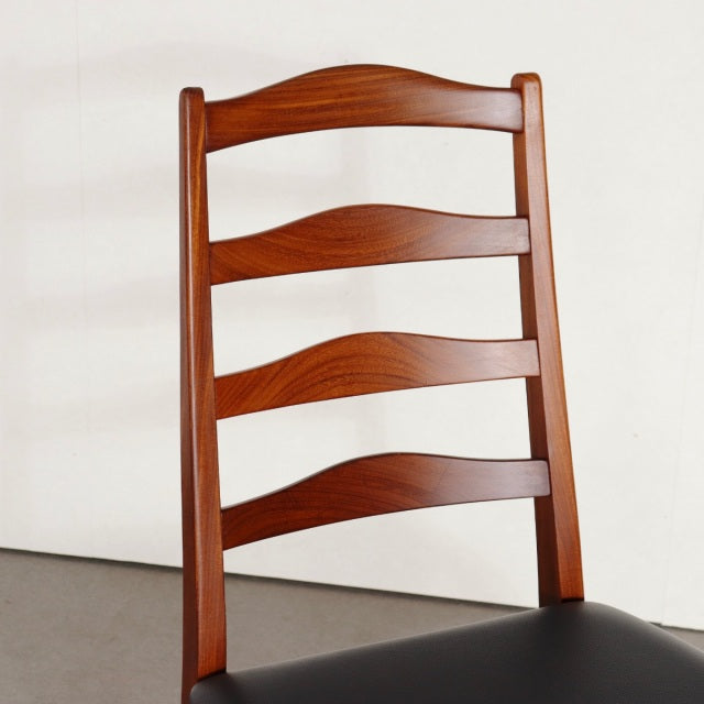 Vintage G-Plan teak dining chair with curved ladder back and black upholstered seat, British mid-century design.