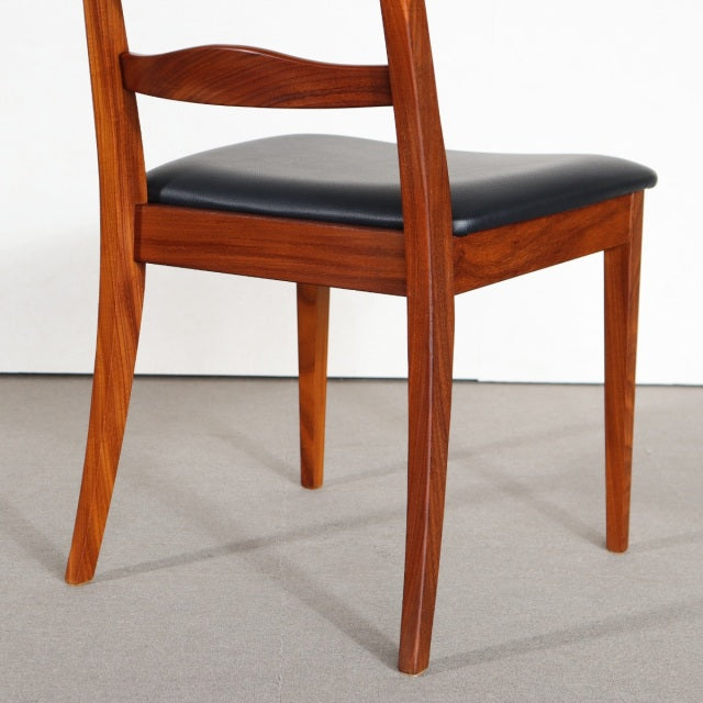 Vintage G-Plan teak dining chair with mid-century British design, black upholstered seat, and tapered legs.