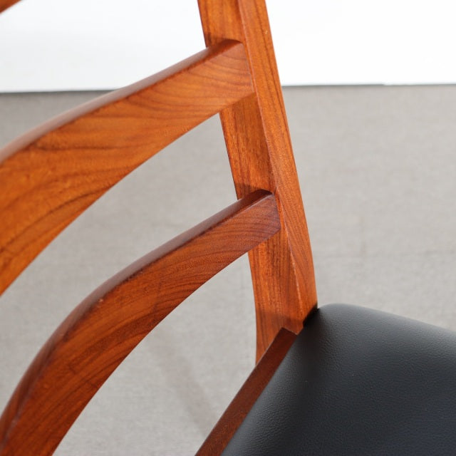 Vintage G-Plan mid-century teak dining chair with angled wooden legs and black upholstered seat, showcasing smooth wood.