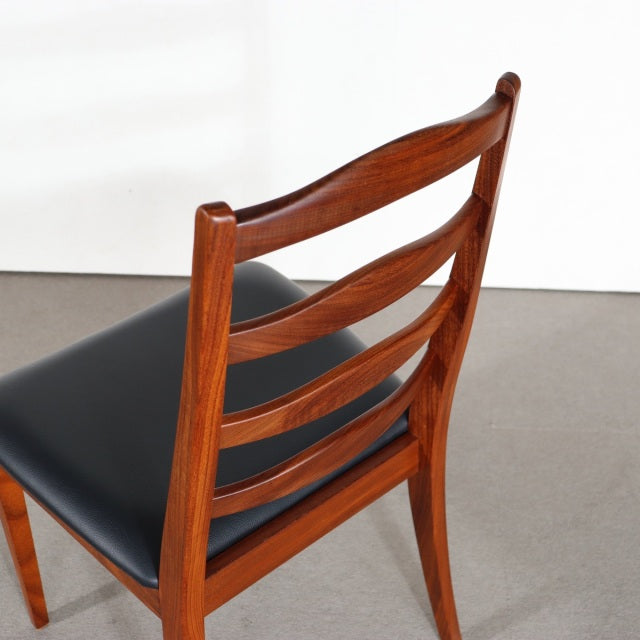 Vintage mid-century G-Plan dining chair in British teak with curved ladder back and black leather seat.