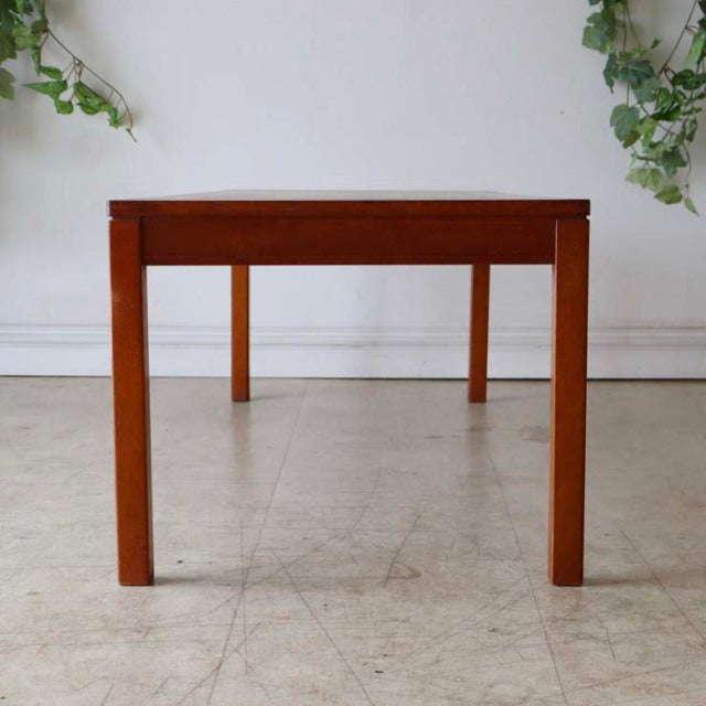Mid-century vintage teak coffee table with clean lines, straight legs, and warm wood grain from British-Danish design.