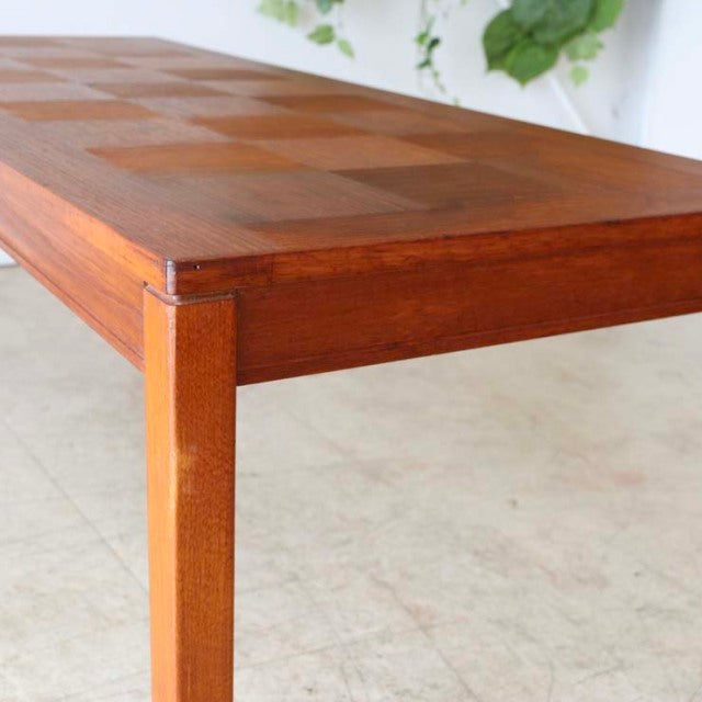 Vintage mid-century teak coffee table with chessboard-patterned rosewood top and slim tapered legs, British Scandinavian.