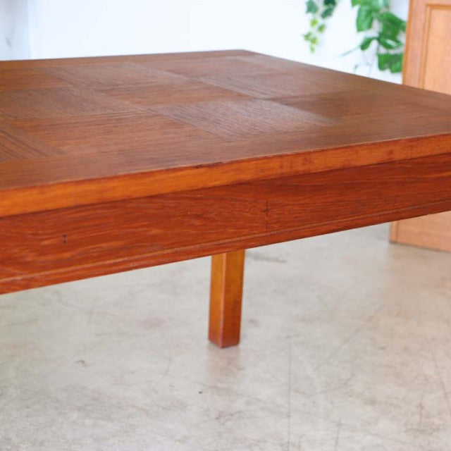 Vintage mid-century teak coffee table with rich rosewood grain, sturdy square legs, sleek British-Denmark design, clean.