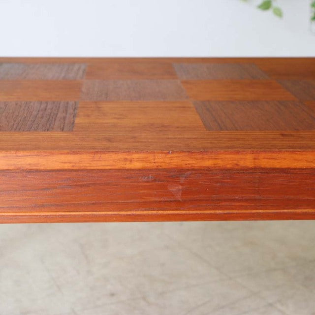 Mid-century vintage rosewood coffee table top with checkerboard teak wood grain from Denmark, showing subtle wear on edges.