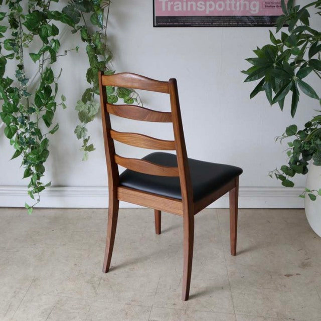 Set of four vintage G-plan teak ladder back dining chairs with black upholstered seats, British mid-century design, sleek.