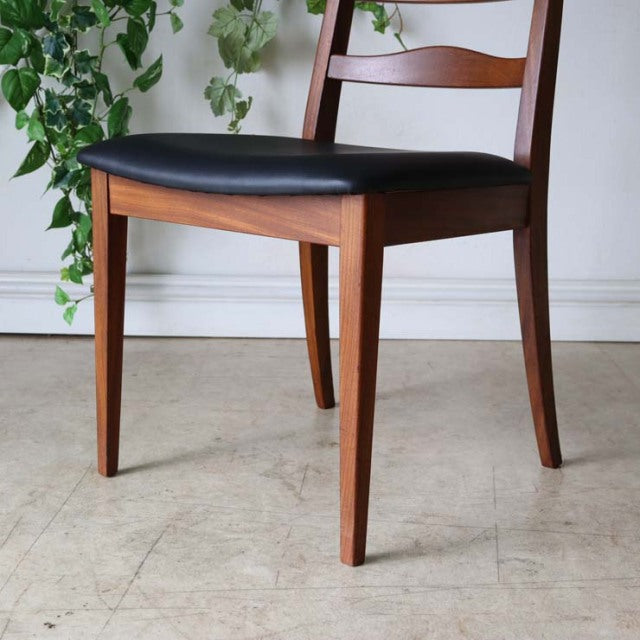 Set of four vintage G-Plan teak dining chairs with ladder backs, black cushioned seats, mid-century British design, slender.