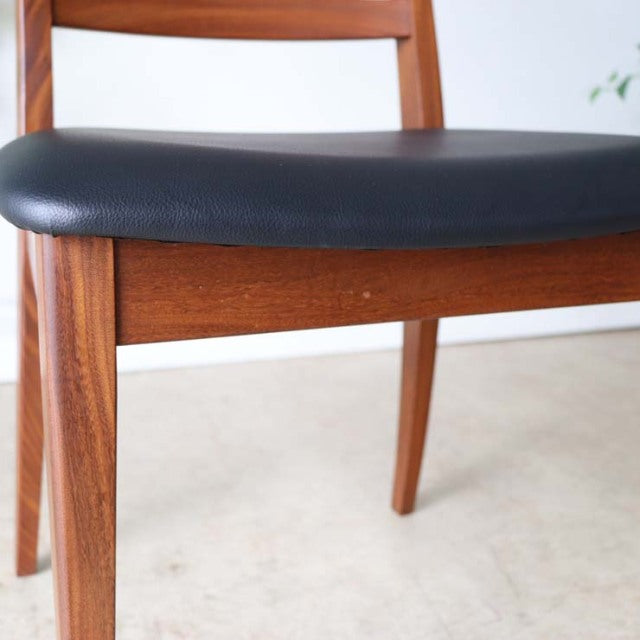 Set of four vintage British G-Plan ladder back dining chairs in mid-century teak with black leather seats and sleek tapered.