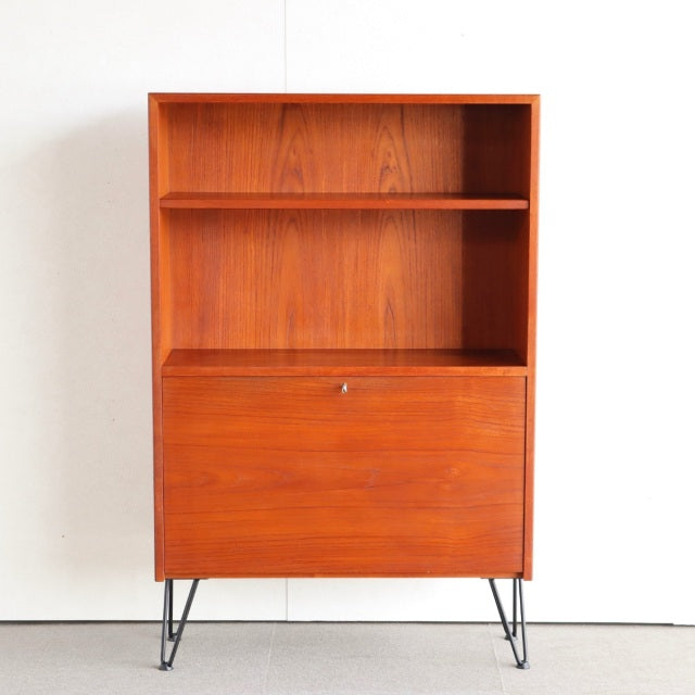 Mid-century vintage teak cabinet with clean wood grain, Denmark design, iron hairpin legs, sleek British-inspired form.