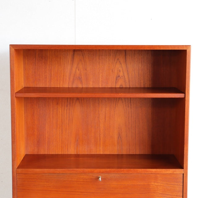Vintage mid-century Danish teak shelf with rich wood grain and minimalist design.