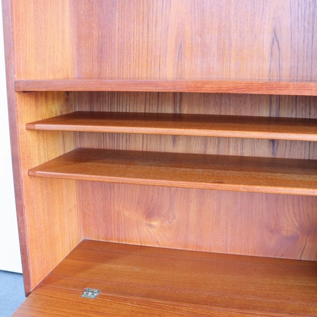 Vintage mid-century teak shelving unit from Denmark with rich wood grain and smooth finish.