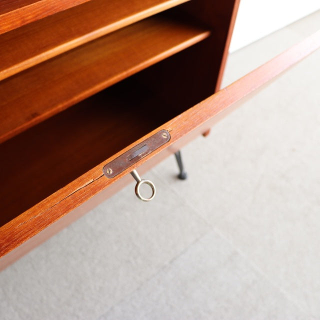Mid-century vintage teak cabinet with fine wood grain, iron legs, and Danish craftsmanship detail.