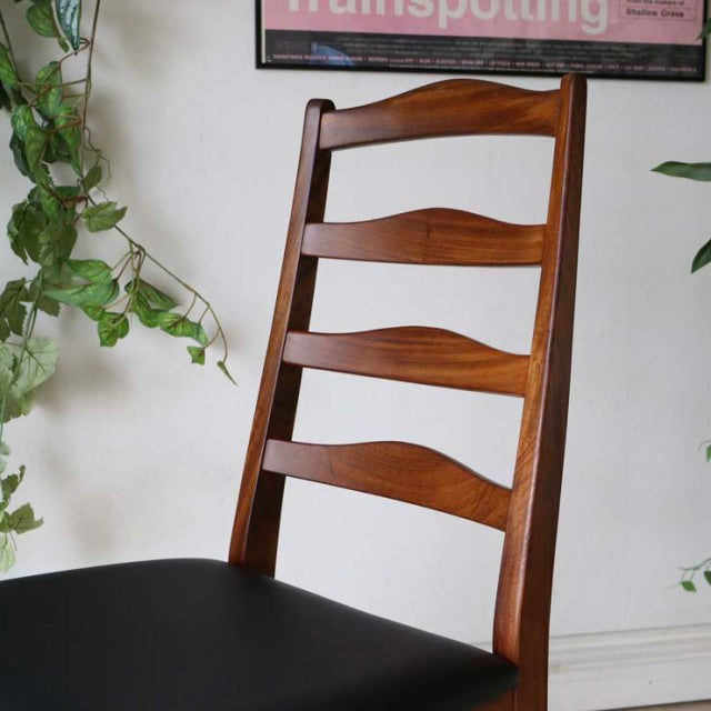Set of four vintage British G-Plan teak ladder-back dining chairs with curved slats and black seats, mid-century Denmark.