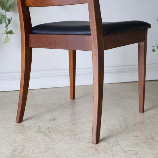 Set of four G-Plan vintage teak dining chairs with ladder back, British mid-century design, smooth wood grain, and curved.
