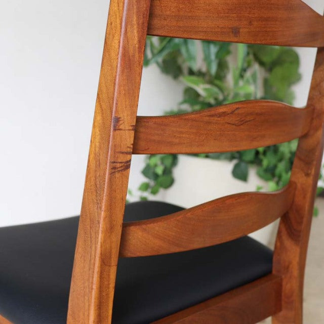 Set of four vintage British mid-century teak ladder back dining chairs with smoothly curved horizontal slats and black.