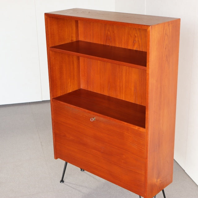 Vintage mid-century Danish teak cabinet with iron legs, clean wood grain, and sleek rectangular form.