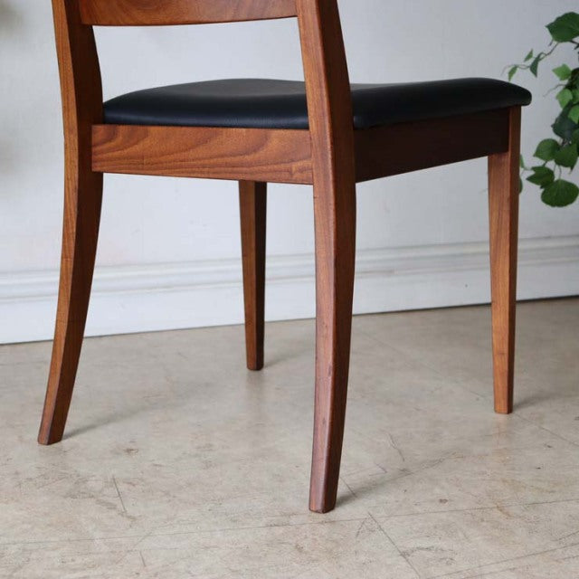 Set of four vintage mid-century British G-Plan ladder back dining chairs in teak with black upholstered seats and tapered.