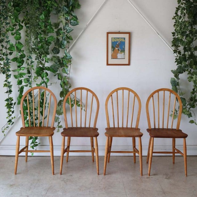 Set of four vintage British Ercol Hoopback chairs in natural teak wood, mid-century design with smooth rounded spindles and.