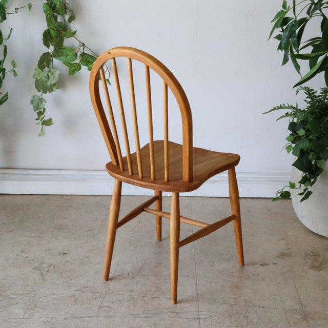 Vintage British mid-century Ercol hoop back dining chair in natural teak with smooth curved wood grain and slender tapered.