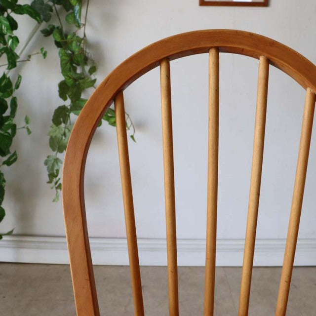 Mid-century British vintage Ercol hoop back dining chair in warm teak wood with smooth curved top rail and slender vertical.