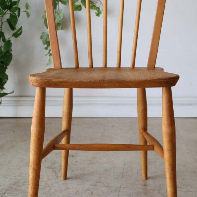 Vintage British mid-century Ercol hoop back dining chair in teak with smooth grain and turned legs.