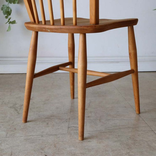Set of four vintage mid-century British Ercol Hoopback chairs in natural teak with smooth wood grain and tapered legs from.