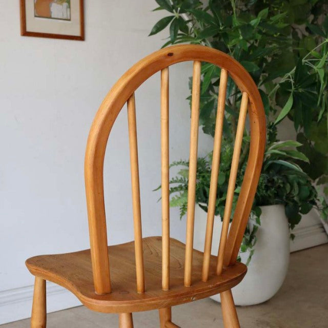 Vintage British mid-century Ercol hoop-back dining chair in warm teak with curved spindle back and tapered legs.