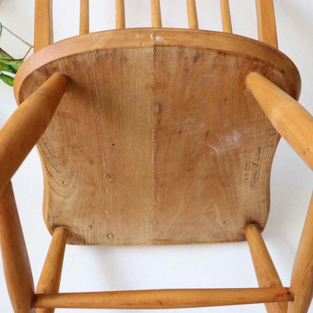 Vintage British mid-century Ercol dining chair seat in solid teak with visible wood grain and rounded legs.