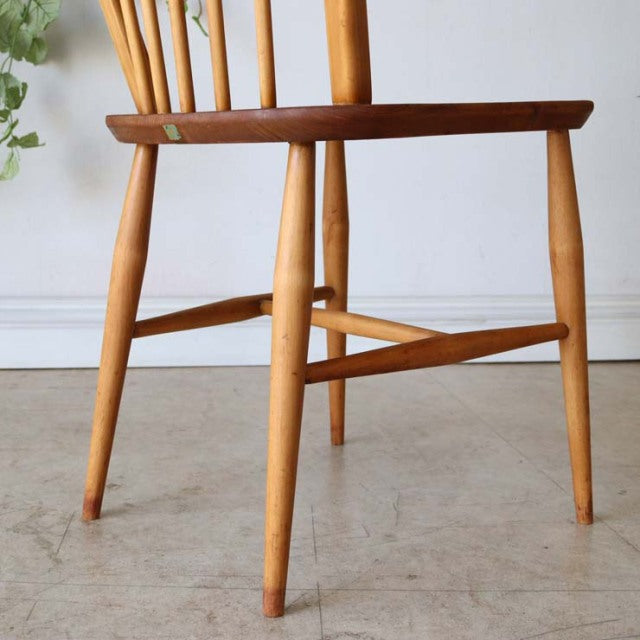 Set of four British mid-century ERCOL Hoopback dining chairs in natural teak with visible wood grain and slender tapered.
