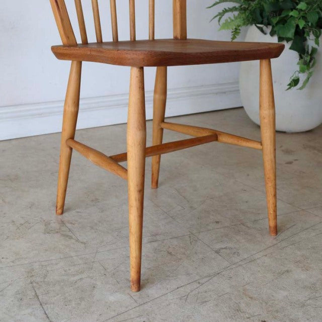 Vintage British mid-century Ercol hoop-back dining chair in teak with natural wood grain seat and light tapered legs.