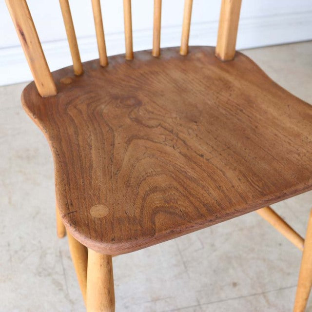Vintage British Ercol dining chair in teak with smooth curved seat and spindle hoop back, mid-century design showing rich.