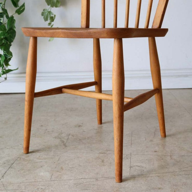 Set of four vintage mid-century ERCOL Hoopback dining chairs in natural teak with smooth wood grain, slender tapered legs,.