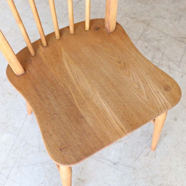 Vintage British mid-century Ercol hoop back dining chair in solid teak with natural wood grain and tapered legs.