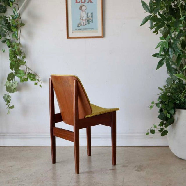 Vintage mid-century teak dining chair by Elliotts of Newbury with clean lines, tapered legs, and curved backrest, showcasing .