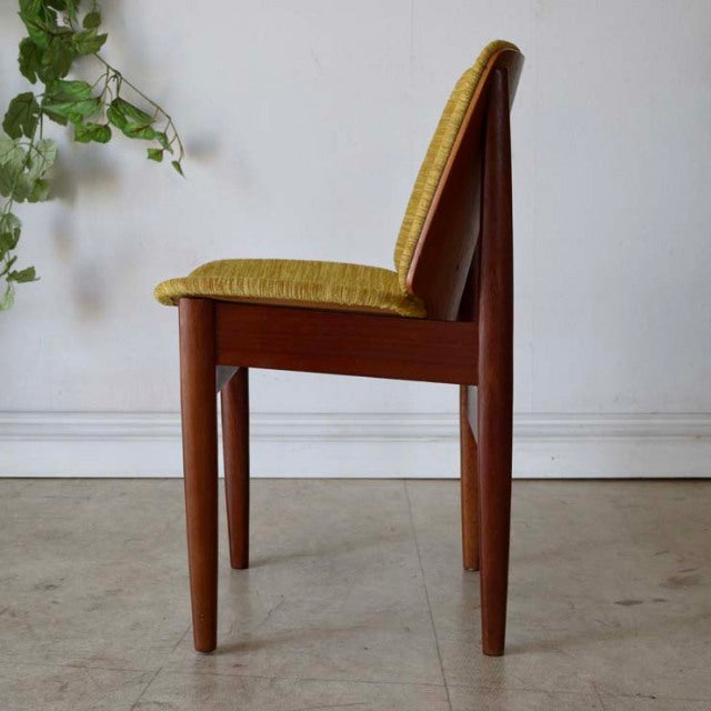 Mid-century British vintage teak dining chair by Elliotts of Newbury with golden olive green upholstered seat and tapered.