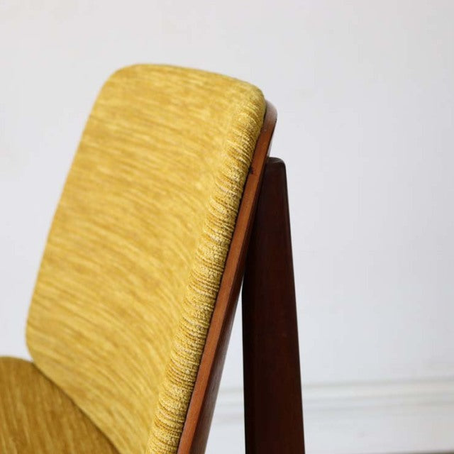 Vintage Elliottsof Newbury mid-century teak dining chair with mustard upholstered cushion and sleek wooden frame.