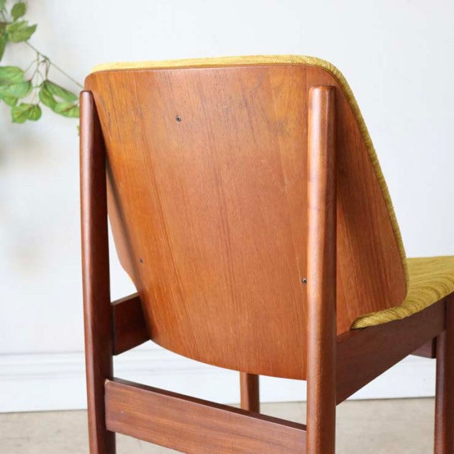 Vintage mid-century British dining chair by Elliotts of Newbury in rich teak with smooth wood grain and slender rounded legs.