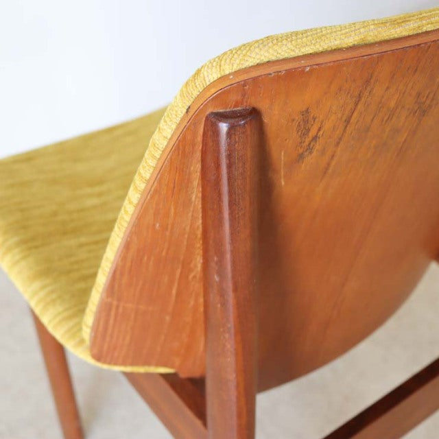 Vintage teak dining chair by Elliotts of Newbury with curved mid-century British design and visible wood grain, featuring a.