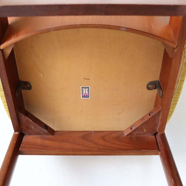Underside view of vintage British Elliottsof Newbury teak dining chair showing sturdy wooden frame, metal brackets, and.